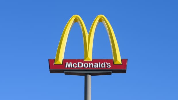 Ellensburg, WA, USA - October 20, 2023; Elevated McDonald's golden arches sign with name isolated against blue sky